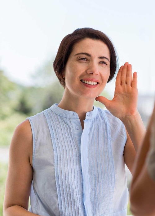 Smiling and signing woman